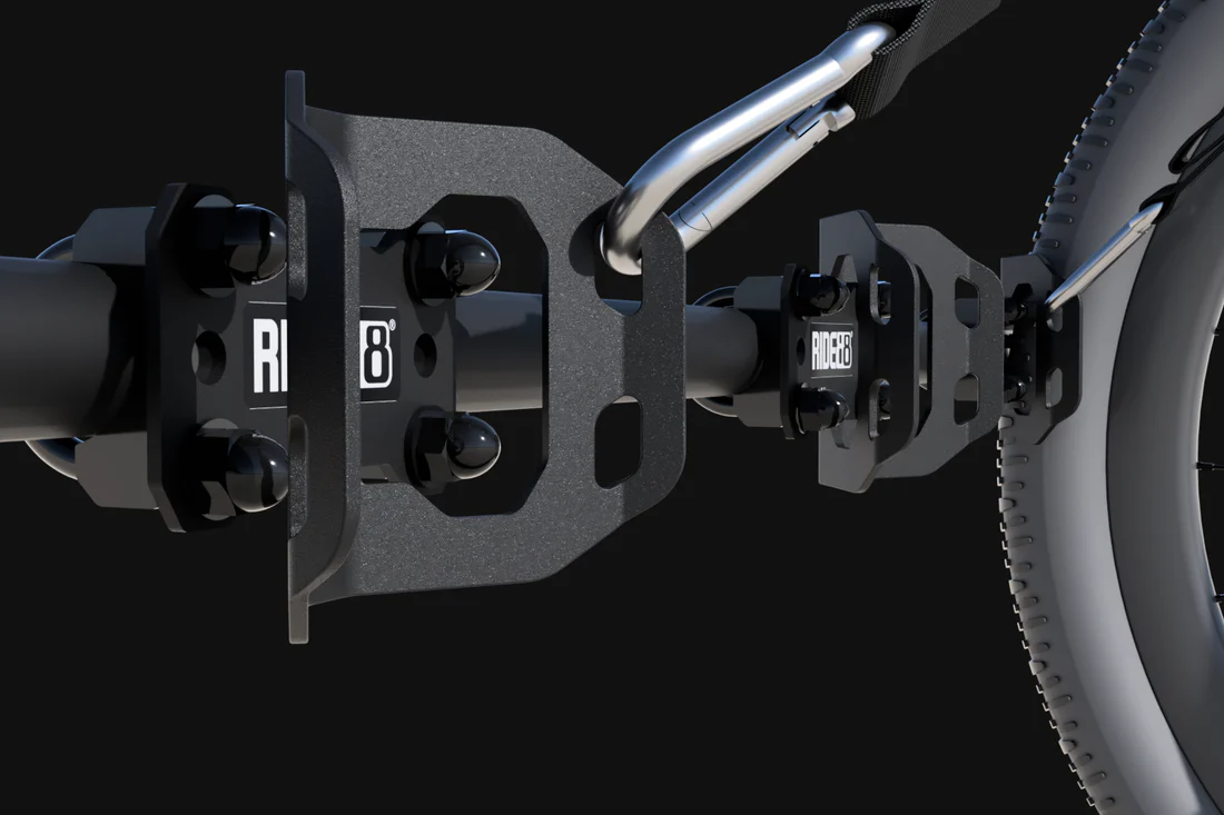 A RIDE88 Cinch Bike Rack. 3 wheel chocks mounted to a crossbar and and 2 tie-downs. A bicycle tire is mounted to the third wheel chock.