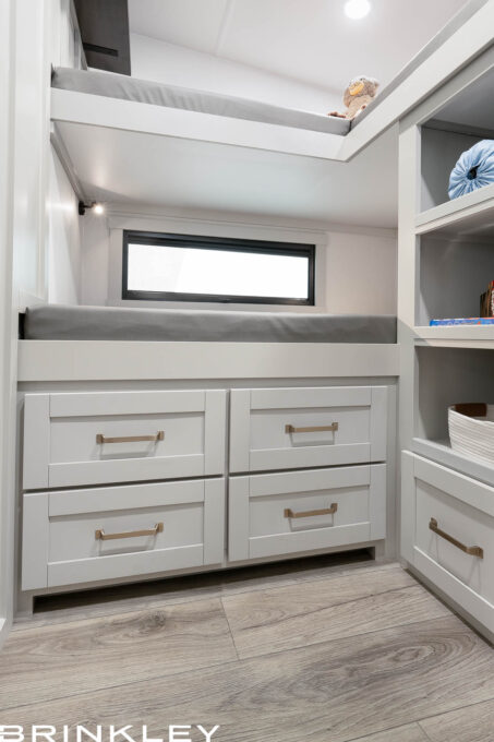 Deep storage drawers located under the bottom bunk in a Brinkley Model Z 2810 Fifth Wheel, showcasing spacious capacity and high-quality dovetail wood construction.