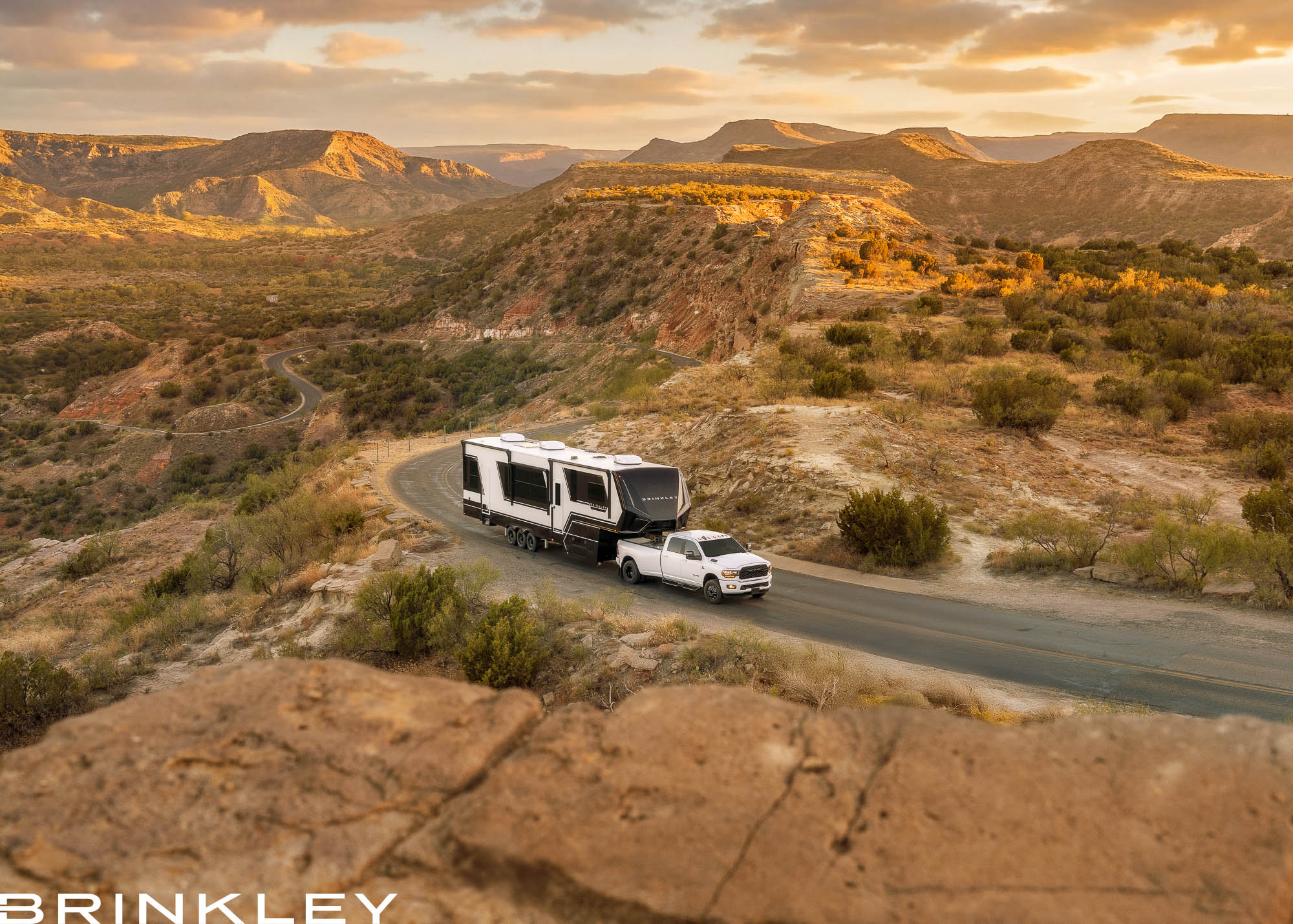 Brinkley Model G Luxury Fifth Wheel Toy Hauler in Premium Exterior Driving in Canyon