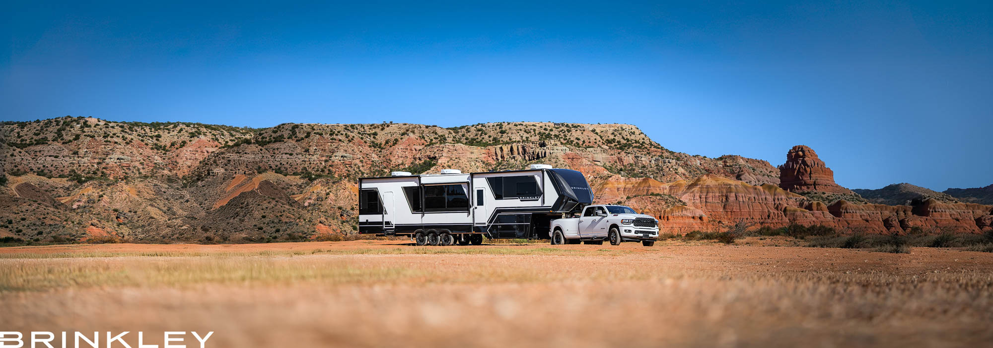 Brinkley Model G Luxury Fifth Wheel Toy Hauler RVing in Palo Duro Canyon State Park in Texas towed by a White Truck 