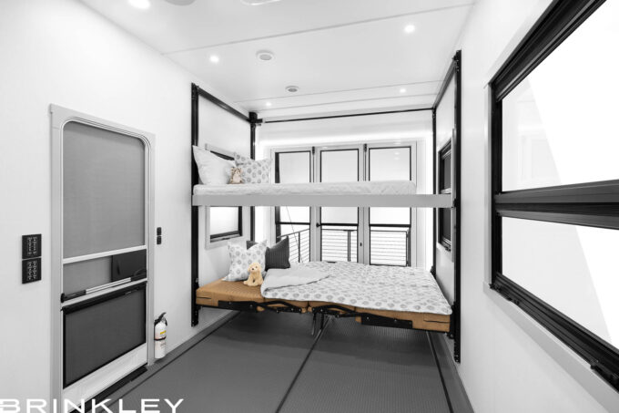RV garage interior showing Happijac overhead bunk lowered and lower sofas converted into a bed.