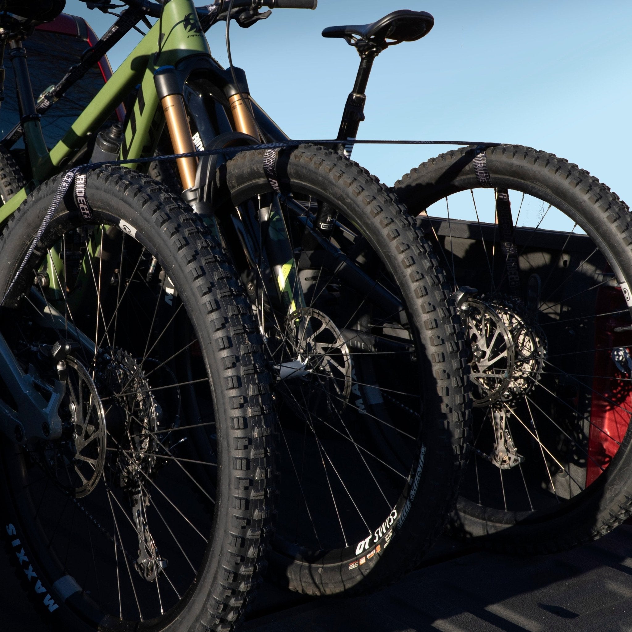 Three bikes mounted in a truck bed using the RIDE88 Cinch Rack truck bed bike rack.